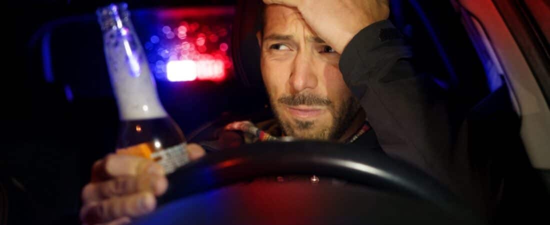 Drunk man driving car. Police stopped driver under alcohol influence at a DUI checkpoint.