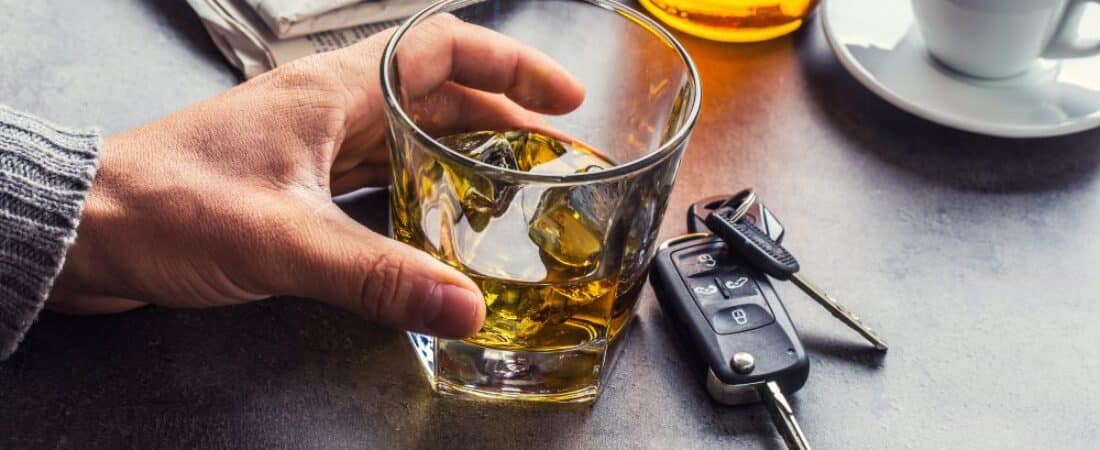 Glass of alcohol hand man the keys to the car and irresponsible driver.