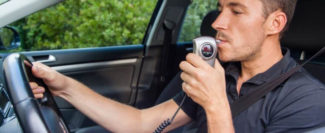 Man blowing into breathalyzer