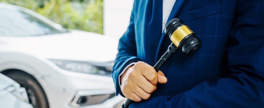 A DUI defense lawyer outside of a garage with a parked car.