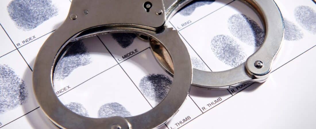 Handcuffs laying on top of fingerprint chart.